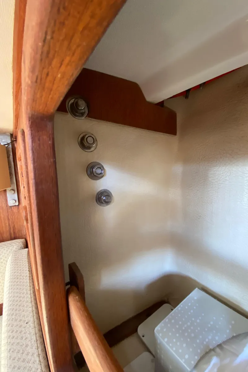Slide: The Image of Interior view of a 1985 Sabre 32 sailboat showing wooden trim and cabin details. - 24