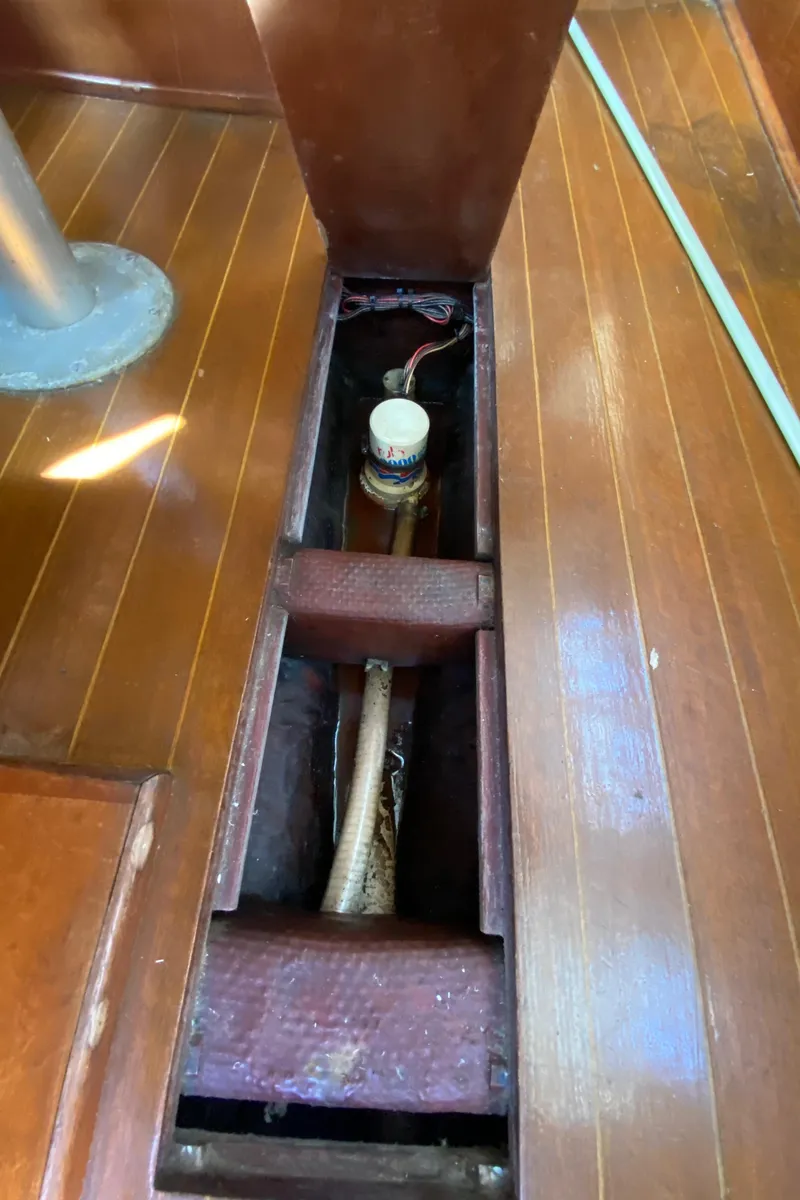 Slide: The Image of Open floor compartment in 1985 Sabre 32 sailboat showing storage and wiring. - 26