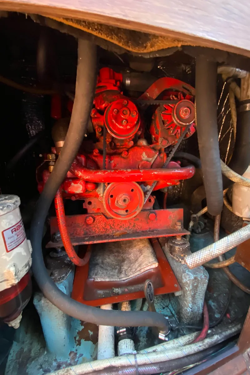 Slide: The Image of 1985 Sabre 32 engine compartment with red engine and hoses. - 27