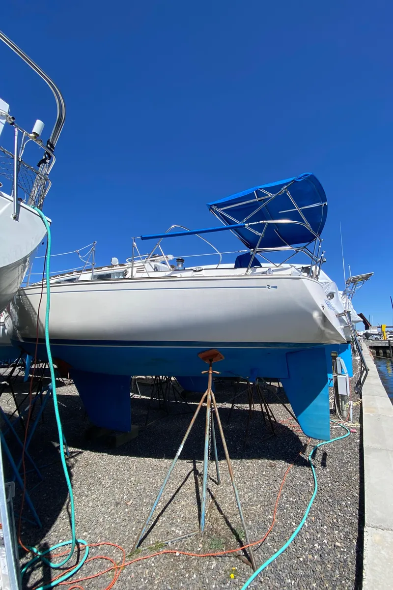 Slide: The Image of 1985 Sabre 32 sailboat on dry dock with blue hull and canopy. - 5