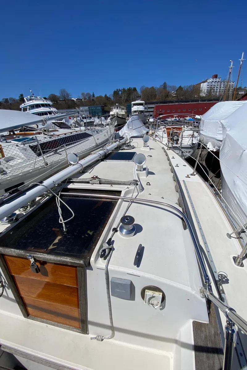 Slide: The Image of 1985 Sabre 32 sailboat docked at a marina on a sunny day. - 8