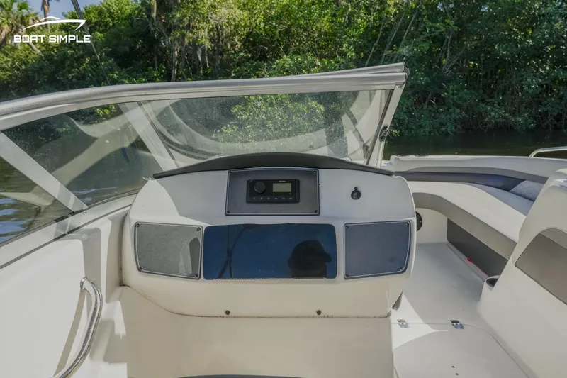 Slide: The Image of 2022 Hurricane 217 SD boat dashboard with windshield and seating area. - 8