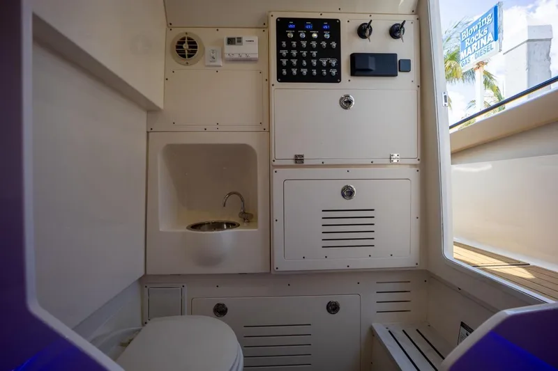 Slide: The Image of 2022 Scout 330 LXF boat interior with sink, toilet, and control panel. - 14