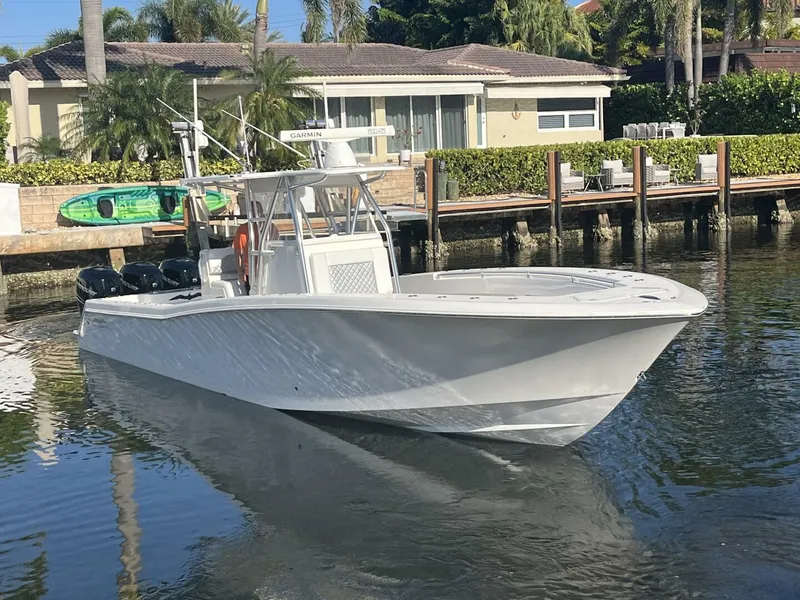 Slide: The Image of 2016 Invincible 36 CC boat docked near waterfront homes. - 1
