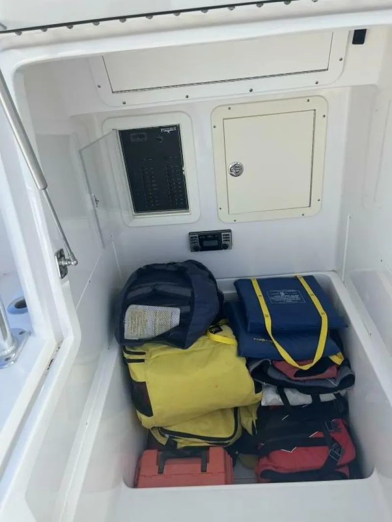 Slide: The Image of Storage compartment of a 2016 Invincible 36 CC boat with safety gear and equipment. - 13