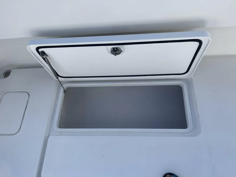 Slide: The Image of Open storage compartment on a 2016 Invincible 36 CC boat. - 14