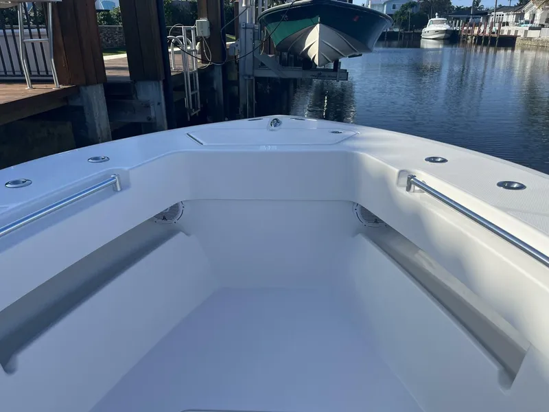 Slide: The Image of 2016 Invincible 36 CC boat bow view at a marina. - 4