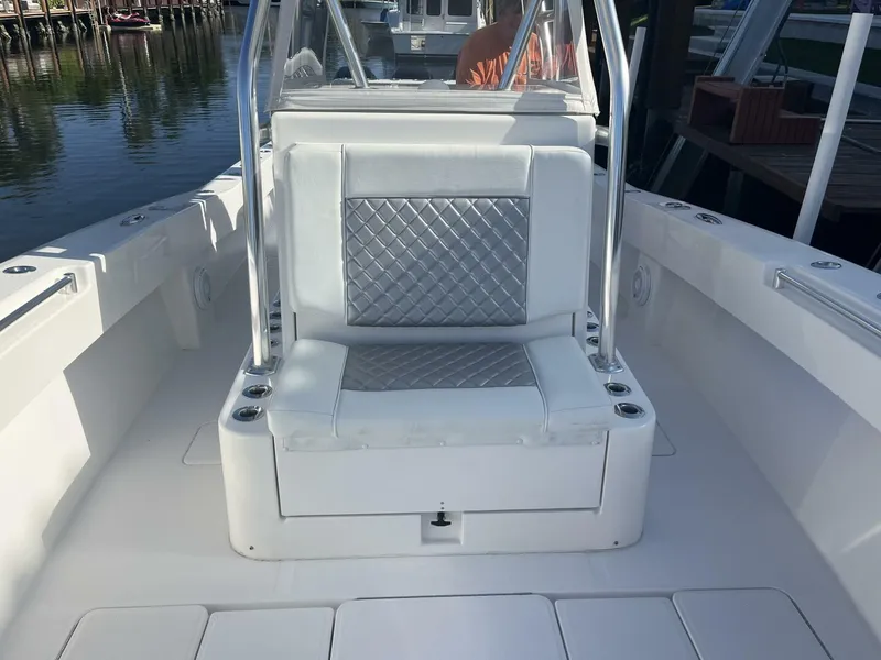 Slide: The Image of 2016 Invincible 36 CC boat with white and silver cushioned seating. - 5