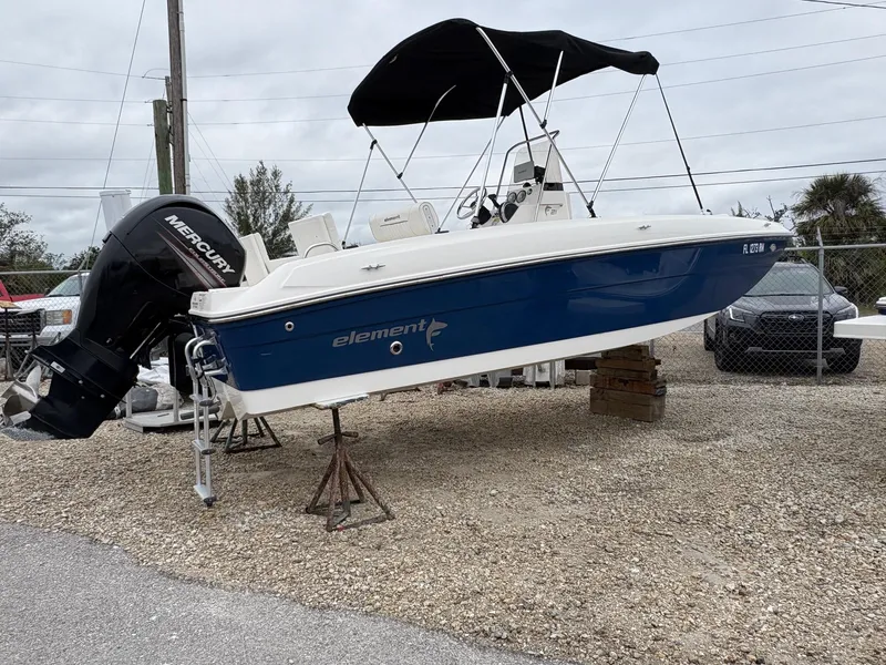 The Image of 2018 Bayliner F21 boat with Mercury engine, displayed on stands, blue and white color. - 1