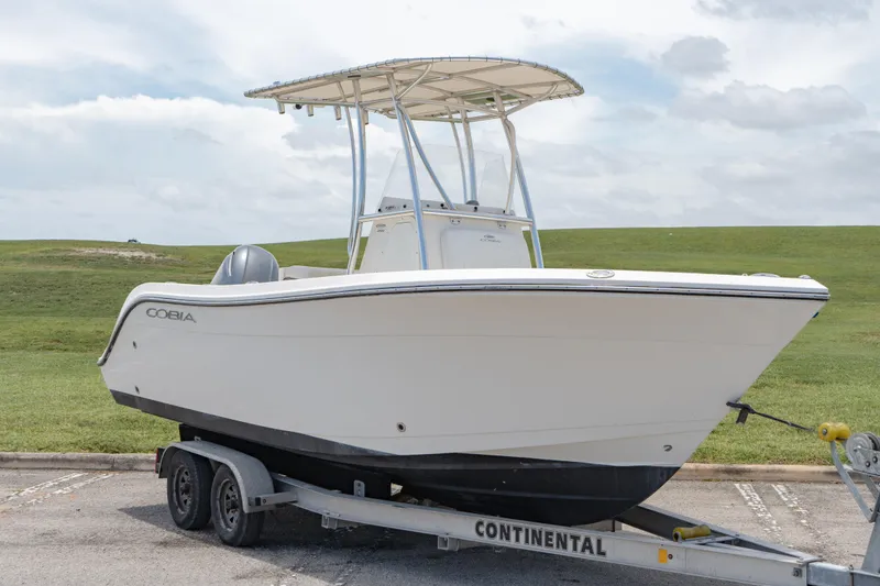 Slide: The Image of 2021 Cobia 201 Center Console boat on a Continental trailer. - 0