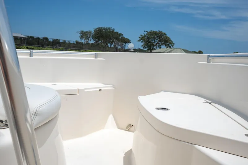 Slide: The Image of 2021 Cobia 201 Center Console boat interior with seating and storage compartments. - 11