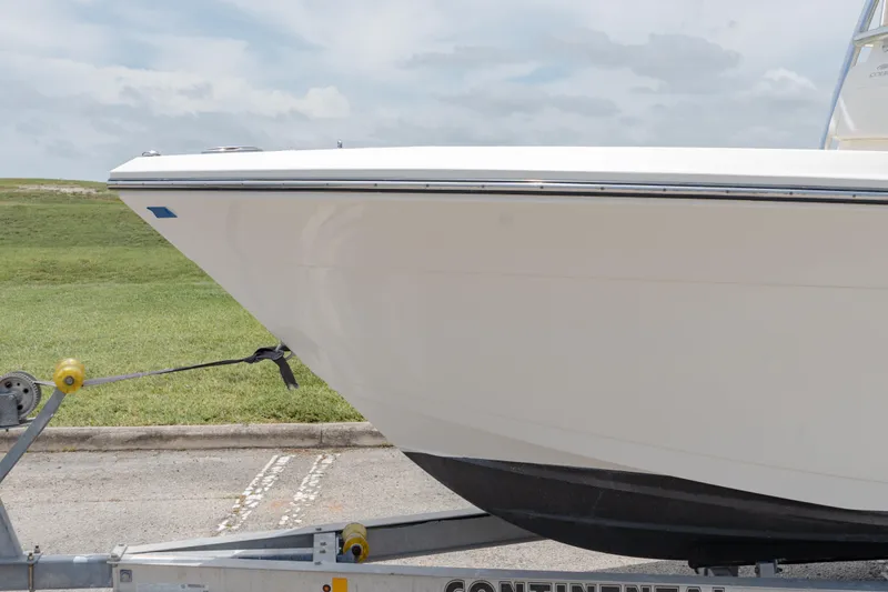 Slide: The Image of 2021 Cobia 201 Center Console boat on trailer, side view. - 5