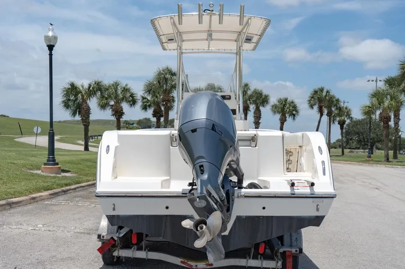 Slide: The Image of 2021 Cobia 201 Center Console boat on trailer, rear view with outboard motor. - 7