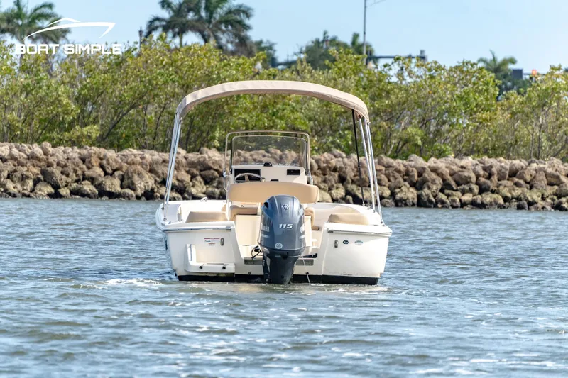Slide: The Image of 2021 Scout 195 Sportfish boat on water with outboard motor. - 1