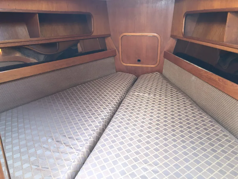 Slide: The Image of Interior cabin of 1988 Nautor Swan 36-2 sailboat with twin beds and wooden shelves. - 10