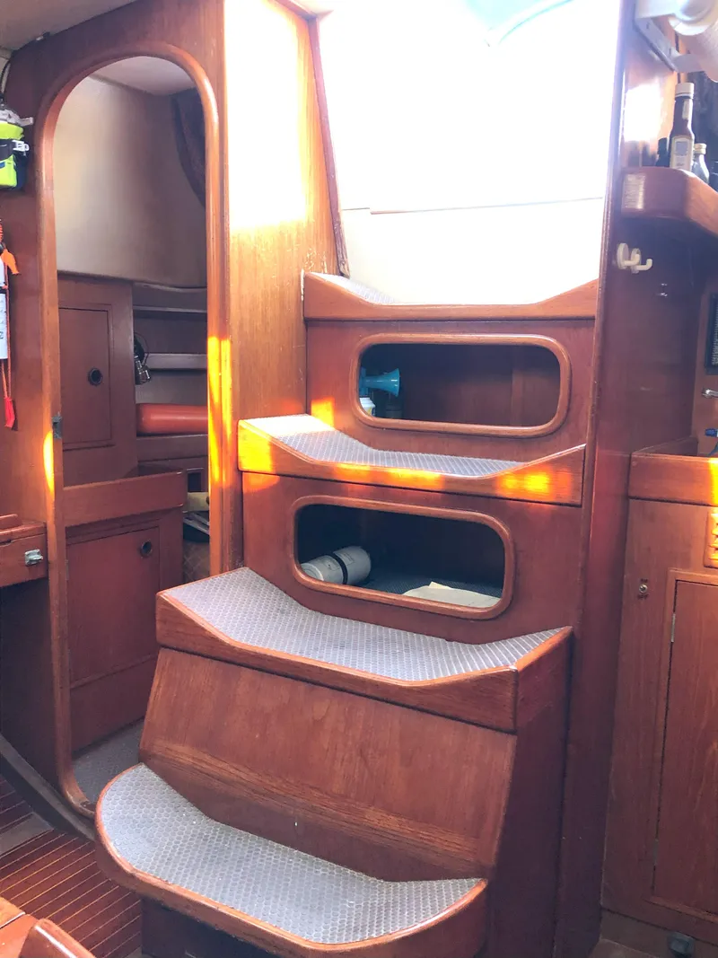 Slide: The Image of Interior of 1988 Nautor Swan 36-2 sailboat with wooden steps and cozy cabin. - 11