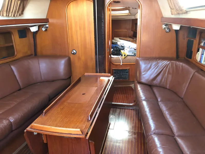 Slide: The Image of Interior of 1988 Nautor Swan 36-2 sailboat with brown leather seating and wooden finishes. - 6