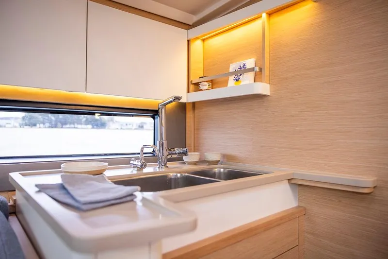 Slide: The Image of Modern kitchen in 2025 Dufour 44 yacht with sleek design and ambient lighting. - 10