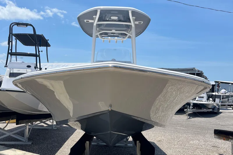 Slide: The Image of 2024 Tidewater 2210 Carolina Bay boat on display in a marina. - 7