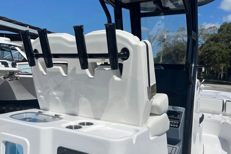 Slide: The Image of 2025 Tidewater 2700 Carolina Bay boat interior with rod holders and seating. - 12