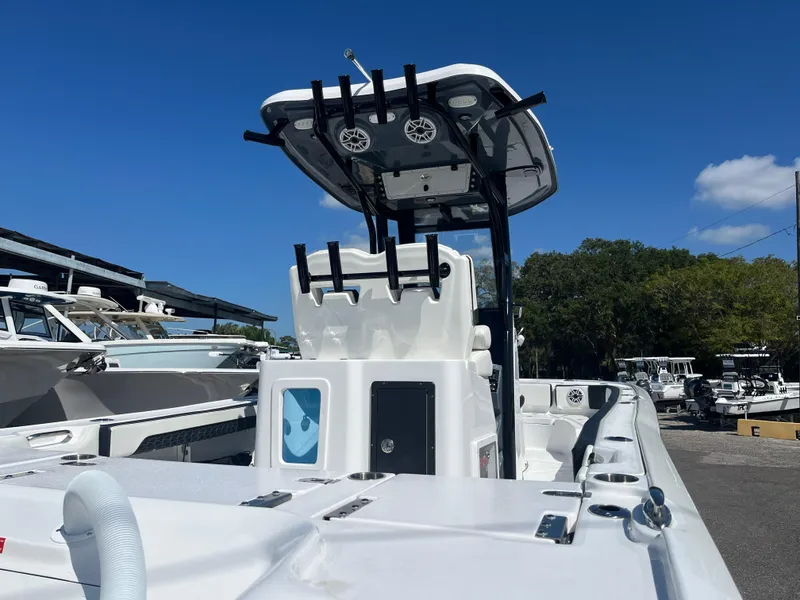 Slide: The Image of 2025 Tidewater 2700 Carolina Bay boat, center console, docked under clear blue sky. - 3