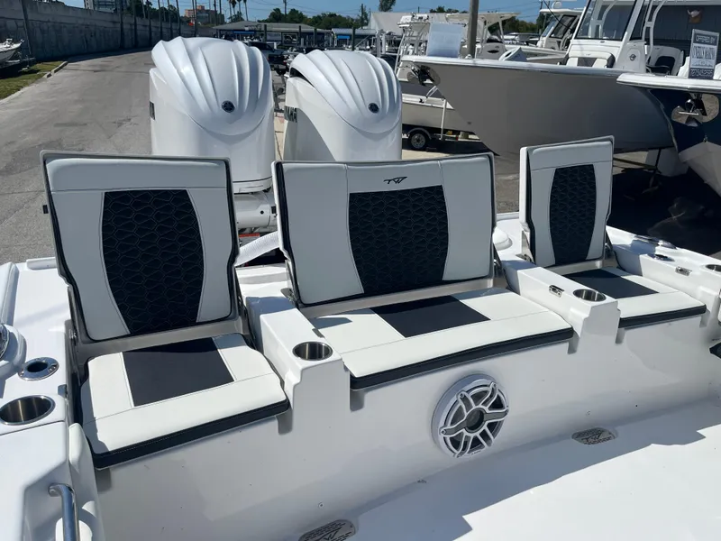Slide: The Image of 2025 Tidewater 2700 Carolina Bay boat with triple seating and twin outboard engines. - 7