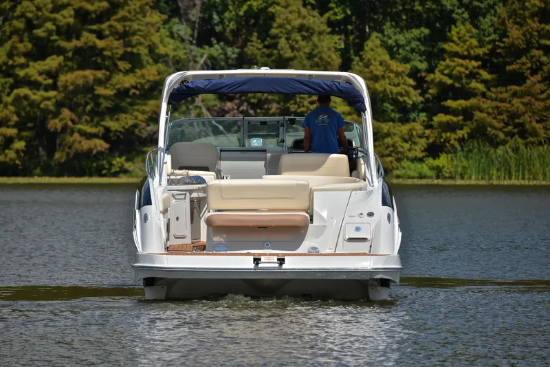 Slide: The Image of Rear view of 2020 Crownline 350 SY boat cruising on a lake. - 10
