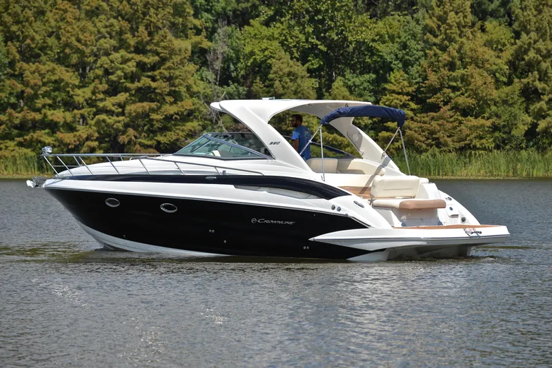 Slide: The Image of 2020 Crownline 350 SY luxury yacht cruising on a serene lake. - 12