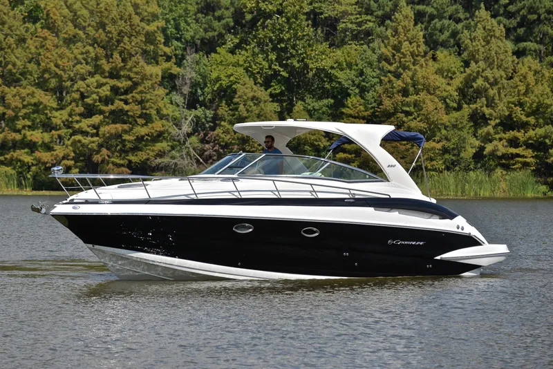 Slide: The Image of 2020 Crownline 350 SY luxury yacht cruising on a serene lake. - 13