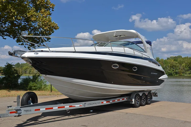 Slide: The Image of 2020 Crownline 350 SY boat on a trailer by a lake. - 15