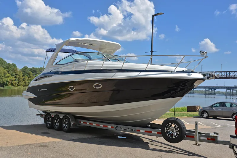 Slide: The Image of 2020 Crownline 350 SY boat on a trailer by a lake. - 21