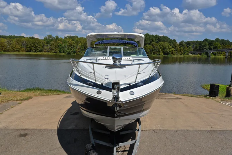 Slide: The Image of 2020 Crownline 350 SY boat on trailer by a lake. - 22