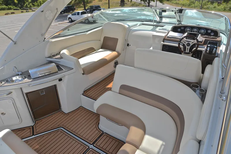 Slide: The Image of 2020 Crownline 350 SY boat interior with luxurious seating and modern dashboard. - 25