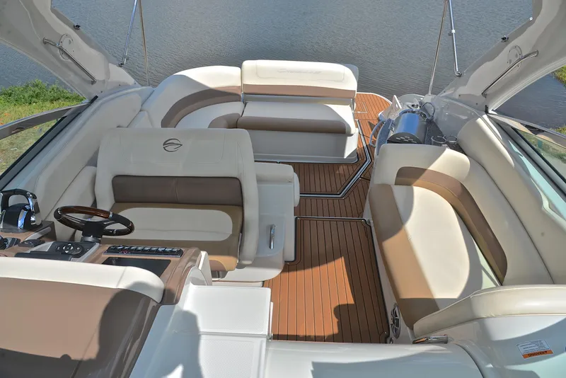 Slide: The Image of 2020 Crownline 350 SY boat interior with luxurious seating and wooden flooring. - 26