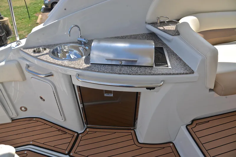 Slide: The Image of 2020 Crownline 350 SY boat kitchenette with sink, grill, and mini-fridge. - 30