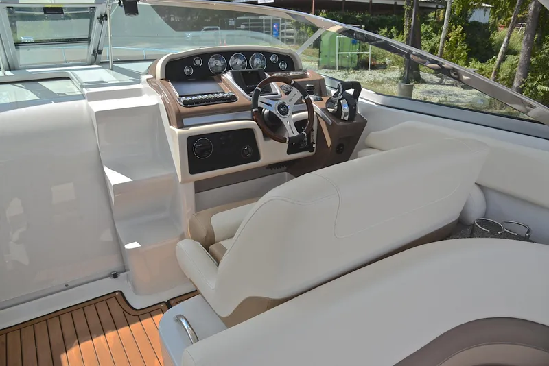 Slide: The Image of 2020 Crownline 350 SY boat helm with modern controls and beige seating. - 33
