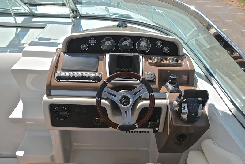 Slide: The Image of 2020 Crownline 350 SY boat dashboard with steering wheel and control panel. - 34