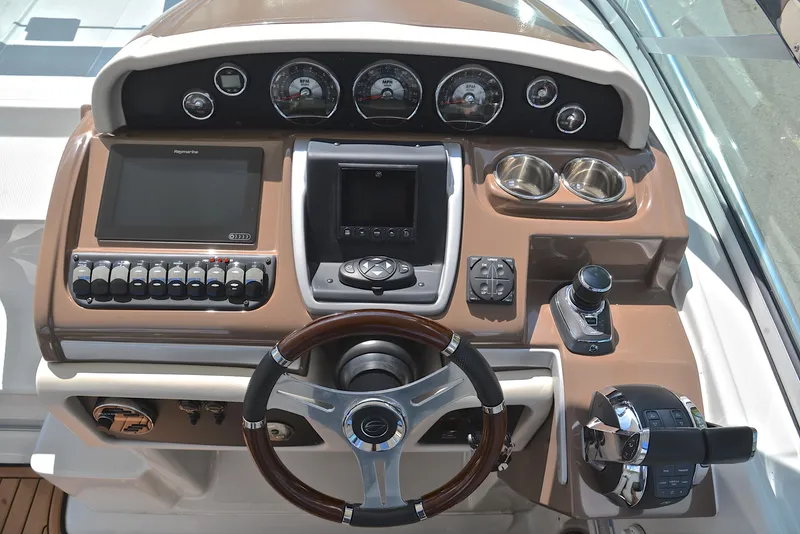 Slide: The Image of Crownline 350 SY 2020 helm station with steering wheel, gauges, and controls. - 35