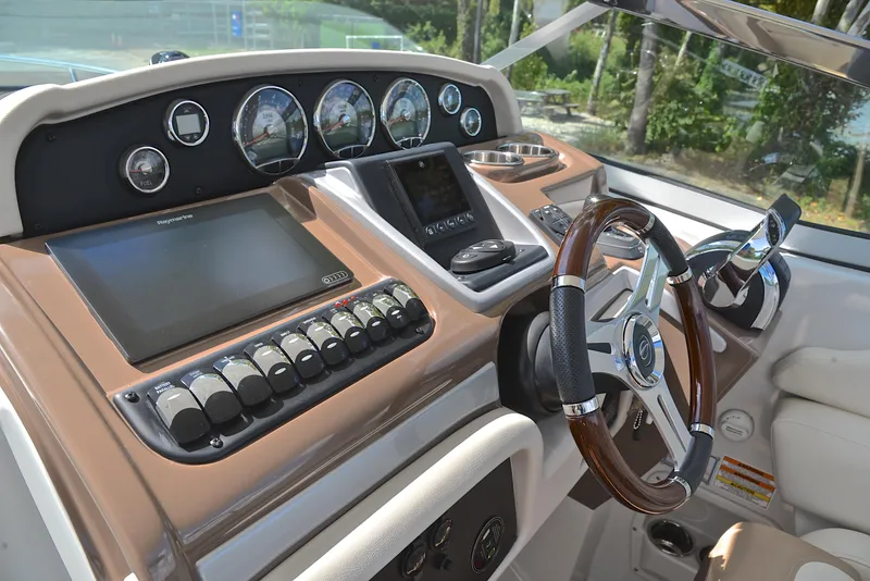 Slide: The Image of 2020 Crownline 350 SY boat helm with modern controls and steering wheel. - 36