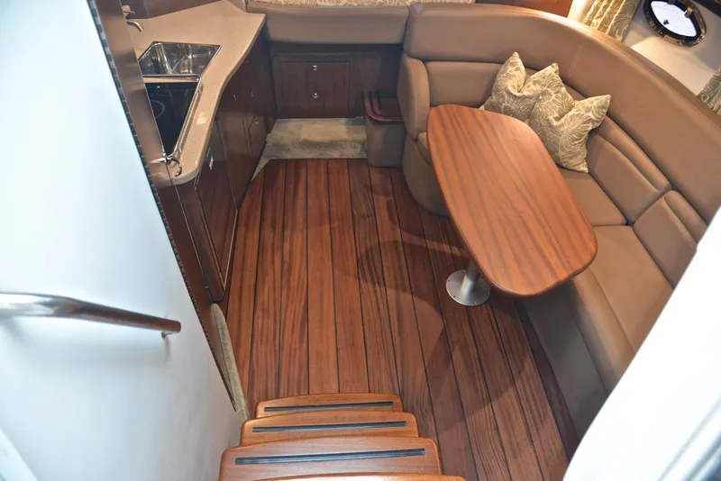 Slide: The Image of Interior of 2020 Crownline 350 SY yacht with wooden flooring and cozy seating area. - 39