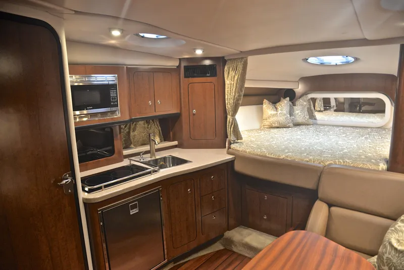 Slide: The Image of Interior of 2020 Crownline 350 SY yacht with kitchen and sleeping area. - 41