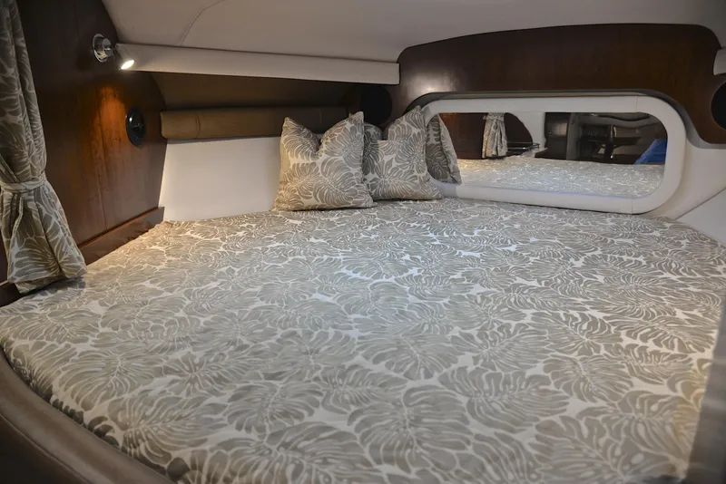 Slide: The Image of Luxurious cabin bed in 2020 Crownline 350 SY yacht with patterned bedding and pillows. - 44