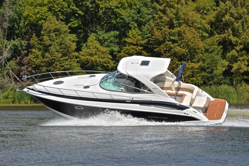 Slide: The Image of 2020 Crownline 350 SY cruising on a lake with lush green trees in the background. - 8