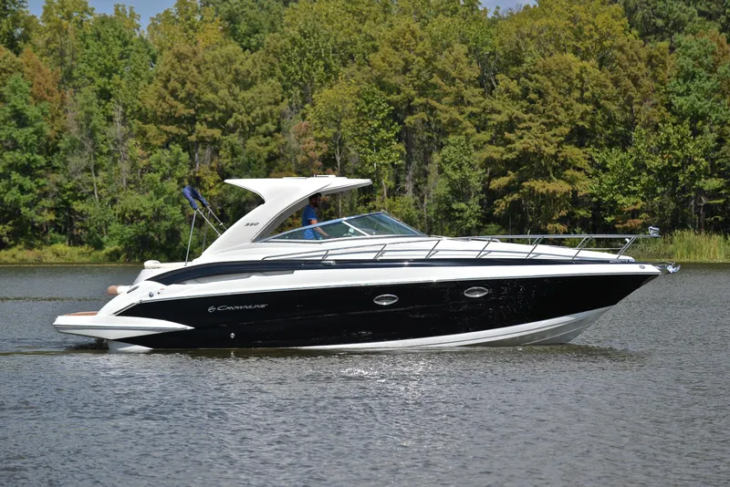 Slide: The Image of 2020 Crownline 350 SY luxury yacht cruising on a serene lake. - 9