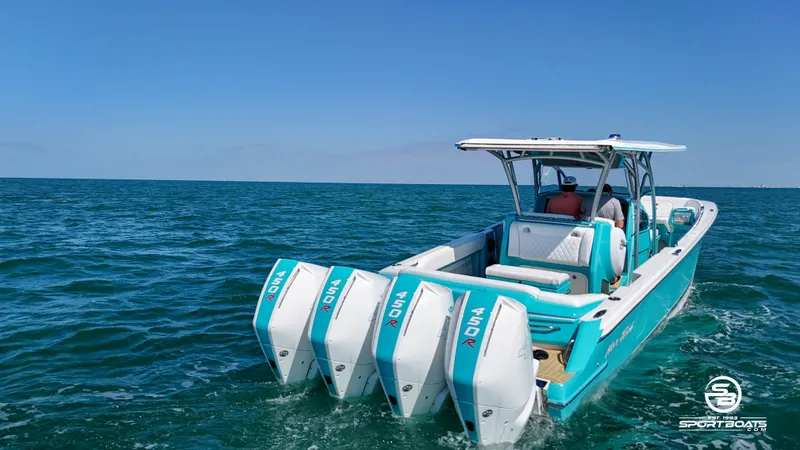 Slide: The Image of 2020 Nor-Tech 390 Sport boat with triple outboard engines on open water. - 13