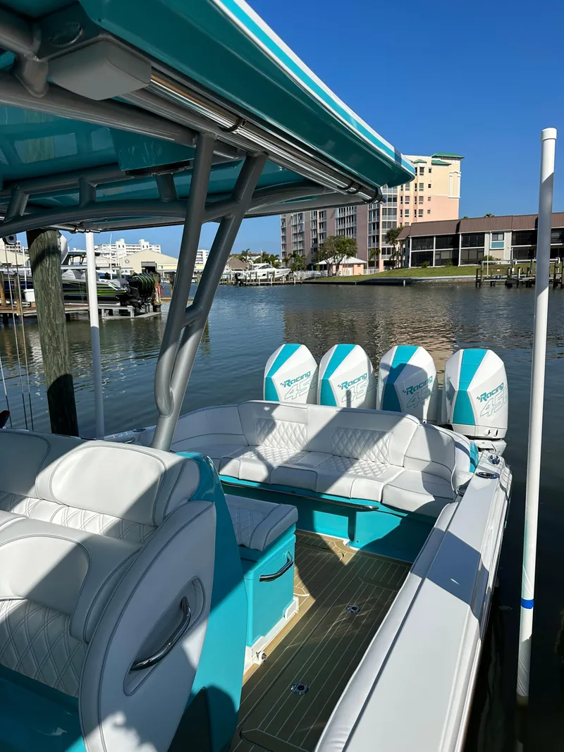 Slide: The Image of 2020 Nor-Tech 390 Sport boat docked with four outboard engines. - 39