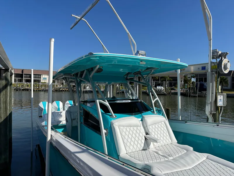 Slide: The Image of 2020 Nor-Tech 390 Sport boat docked, featuring turquoise and white seating. - 44