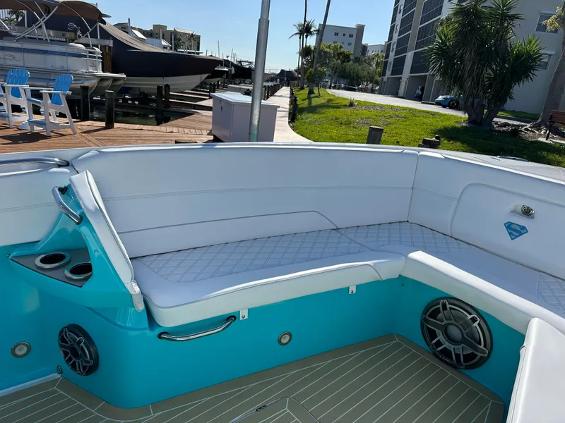 Slide: The Image of 2020 Nor-Tech 390 Sport boat with white seating and turquoise accents. - 46