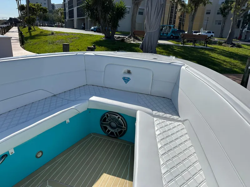 Slide: The Image of 2020 Nor-Tech 390 Sport boat interior with white seating and teal accents. - 47