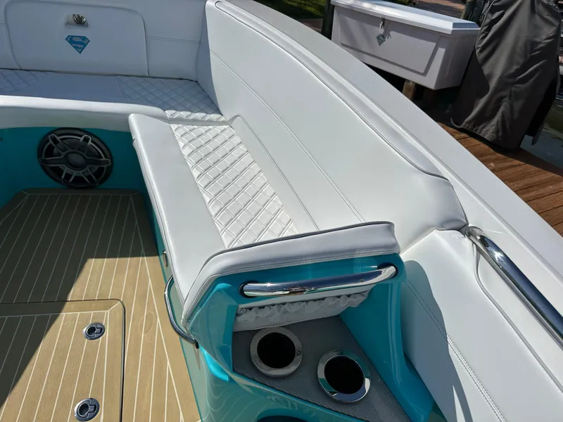 Slide: The Image of 2020 Nor-Tech 390 Sport boat interior with white and turquoise seating and cup holders. - 48